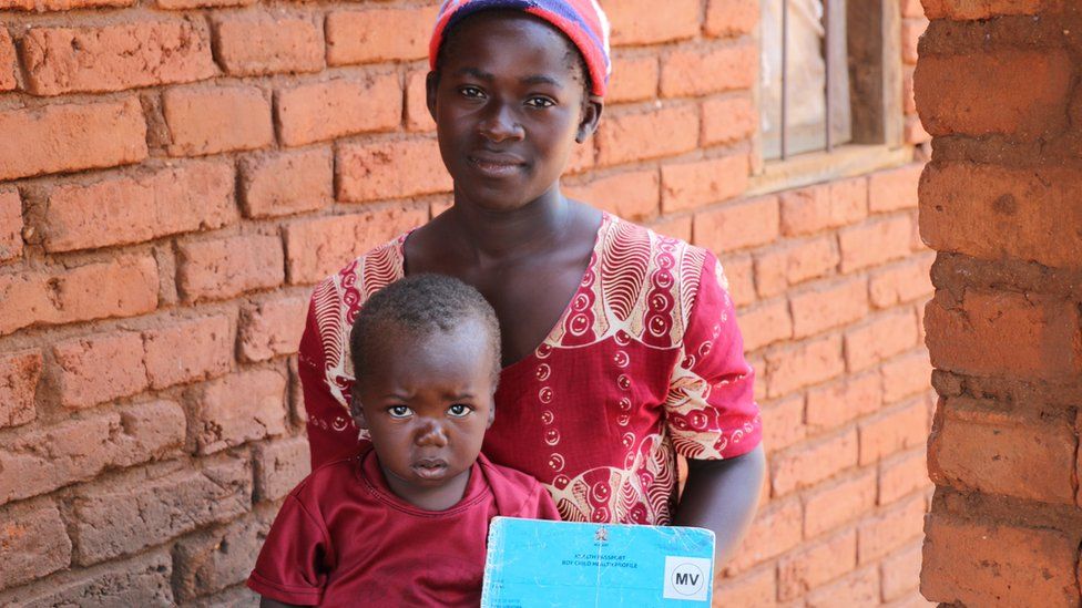 Evison and his mother after receiving his vaccine in Malawi. He was the second child vaccinated in Malawi for the malaria vaccine implementation program.